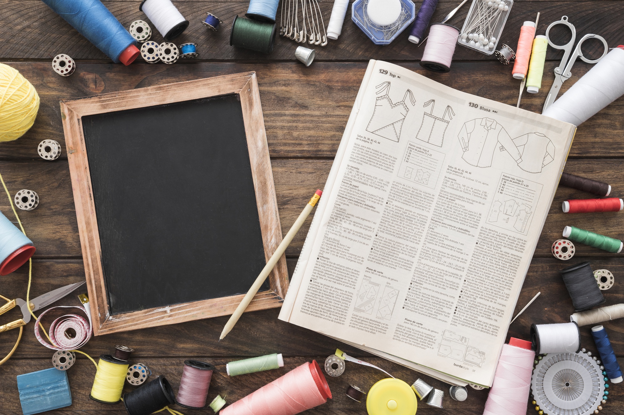 atelier table with threads, hoops and sketches