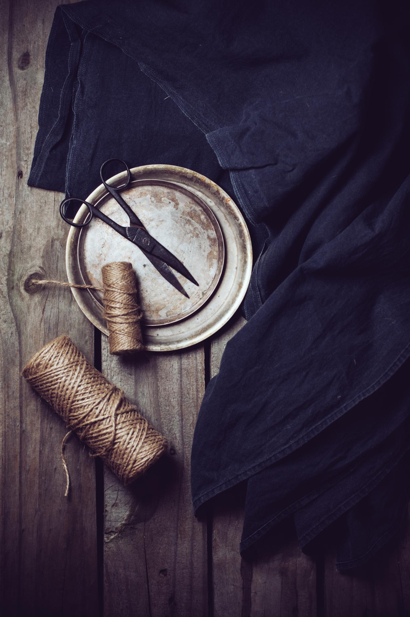 large editorial shot of embroidered textile on a wooden table